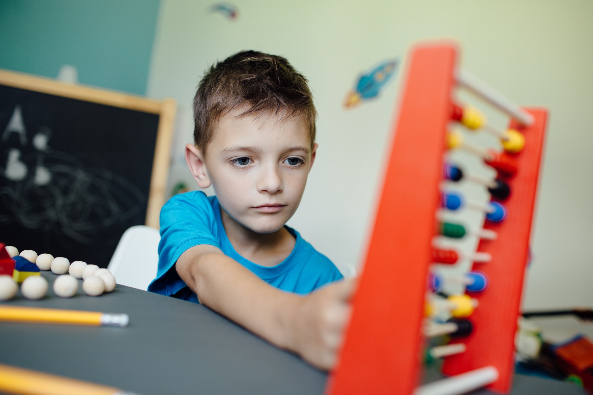 Schoolboy learning maths with an abacus